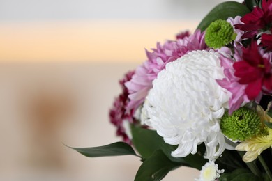 Photo of Bouquet of beautiful chrysanthemum flowers on blurred background, closeup. Space for text