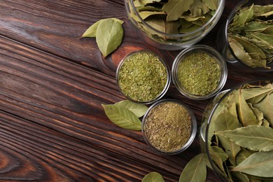 Photo of Whole and ground bay leaves on wooden table, flat lay. Space for text