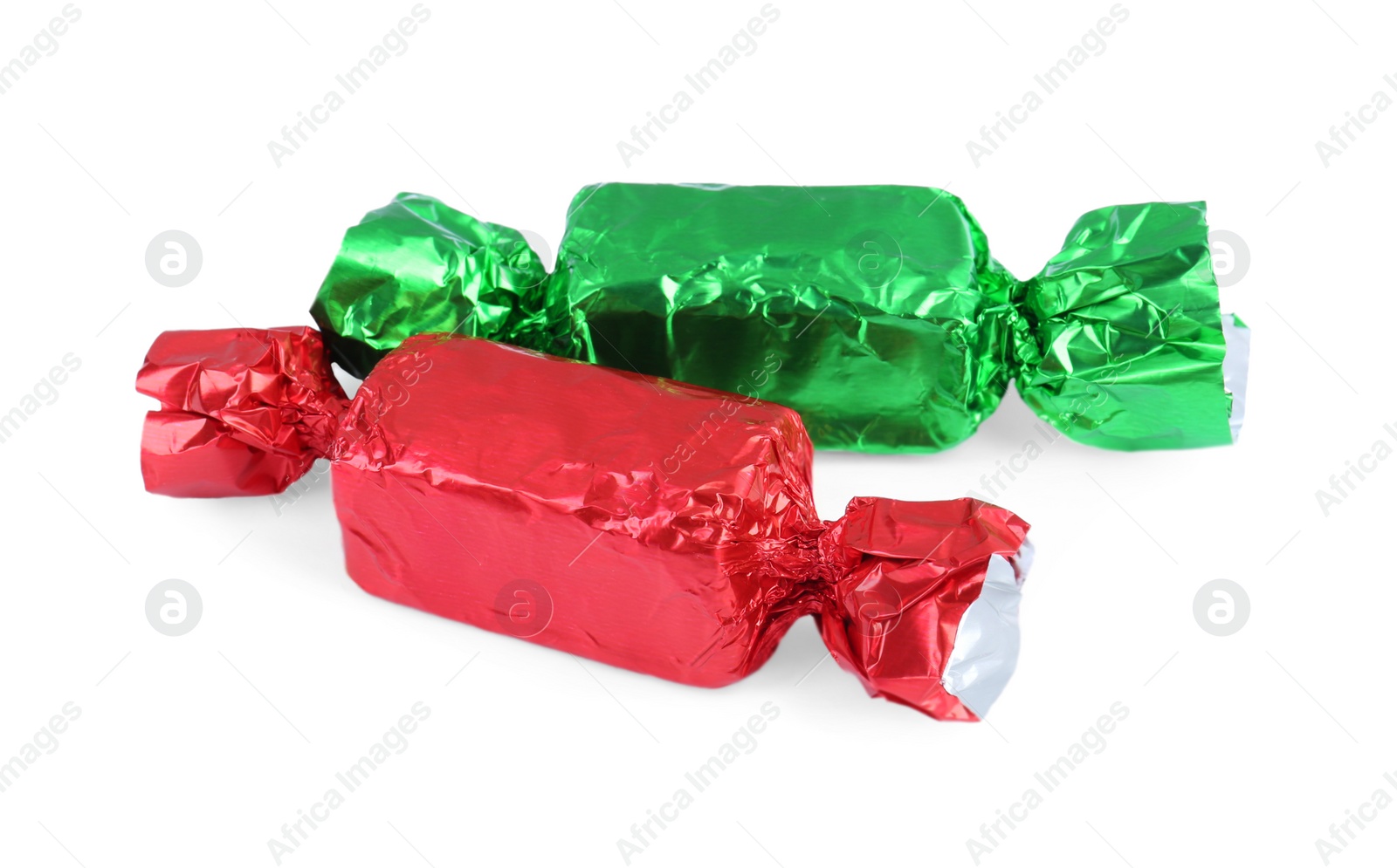 Photo of Two candies in colorful wrappers isolated on white