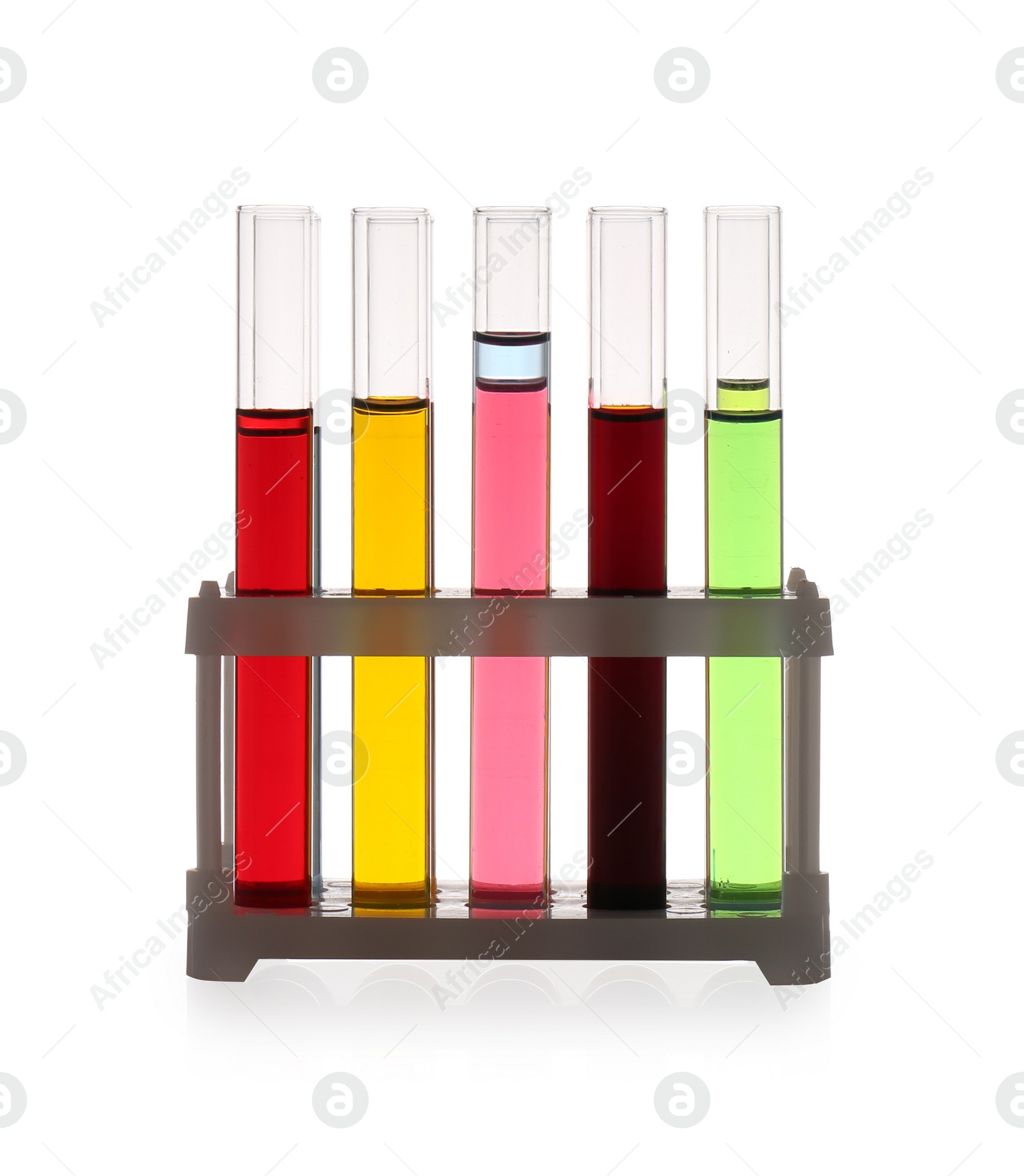 Photo of Rack with test tubes of color liquids isolated on white. Solution chemistry