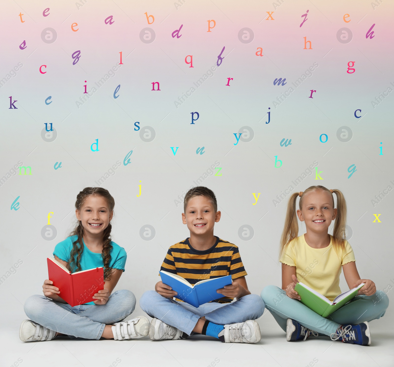 Image of Group of little children reading books on grey background 