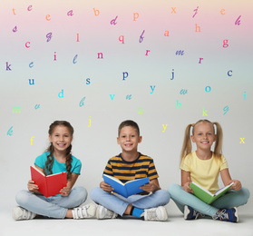 Image of Group of little children reading books on grey background 