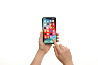 MYKOLAIV, UKRAINE - JULY 9, 2020: Woman holding  iPhone X with home screen on white background, closeup