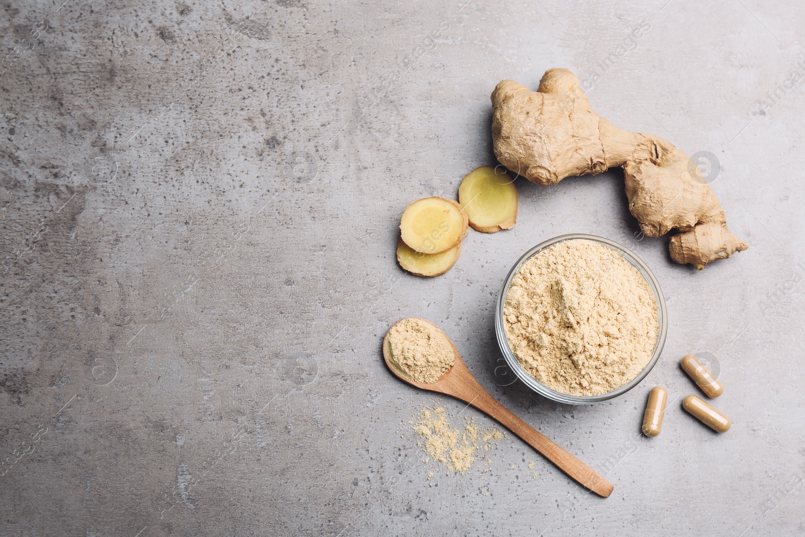 Photo of Dry, fresh and capsuled ginger on grey table, flat lay. Space for text