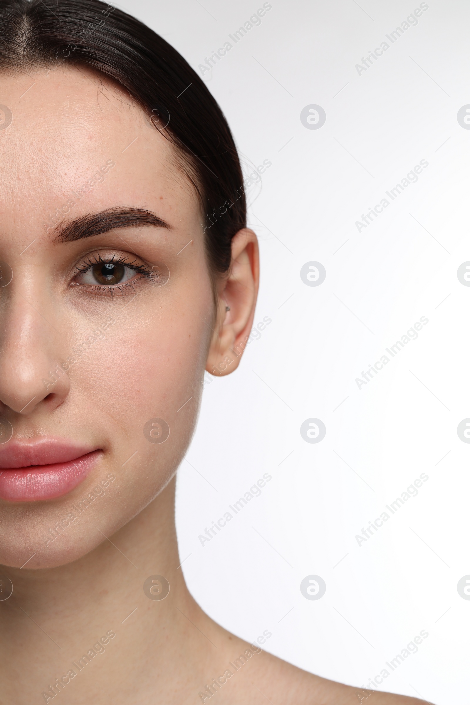 Photo of Beautiful young woman with healthy skin on white background, closeup