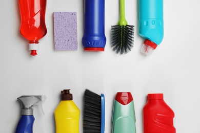 Flat lay composition with cleaning supplies on white background