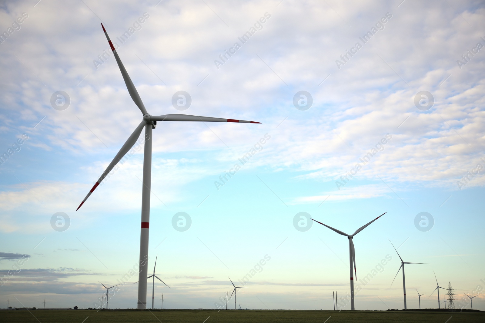 Photo of Beautiful view of field with wind turbines. Alternative energy source