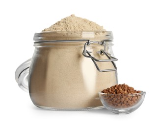 Photo of Glass jar of buckwheat flour on white background
