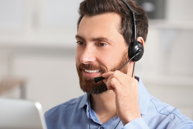 Photo of Hotline operator with headset working in office, space for text