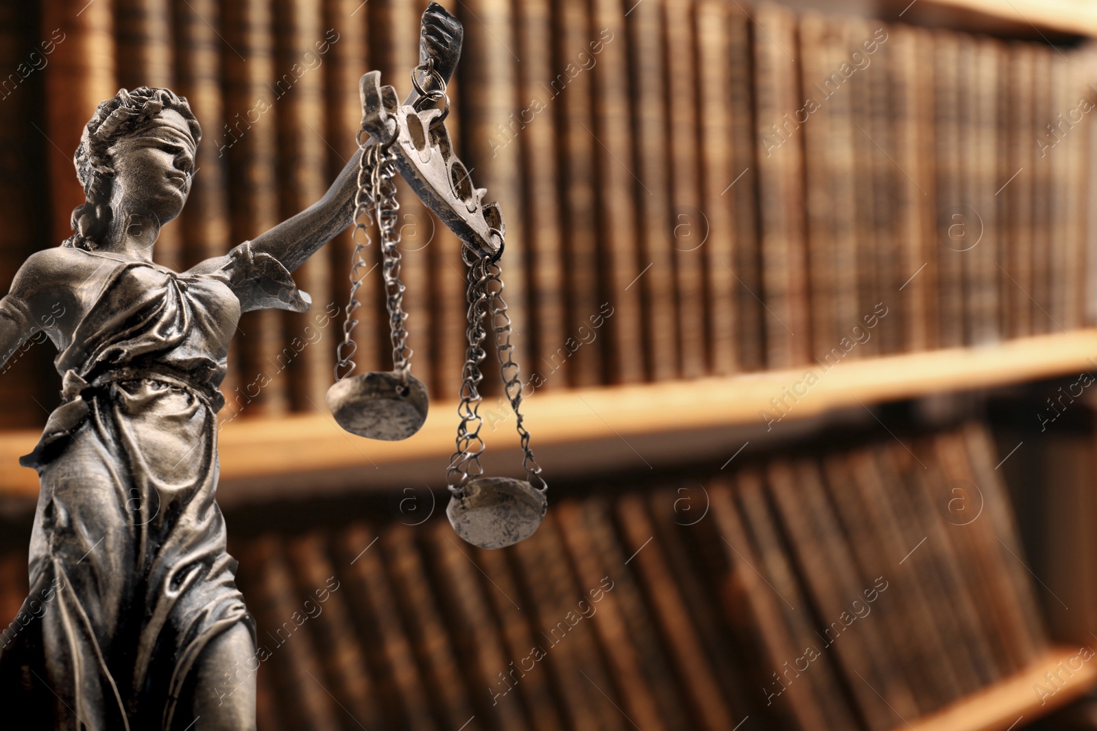 Image of Law and wisdom. Statue of Lady Justice near shelves with books, space for text