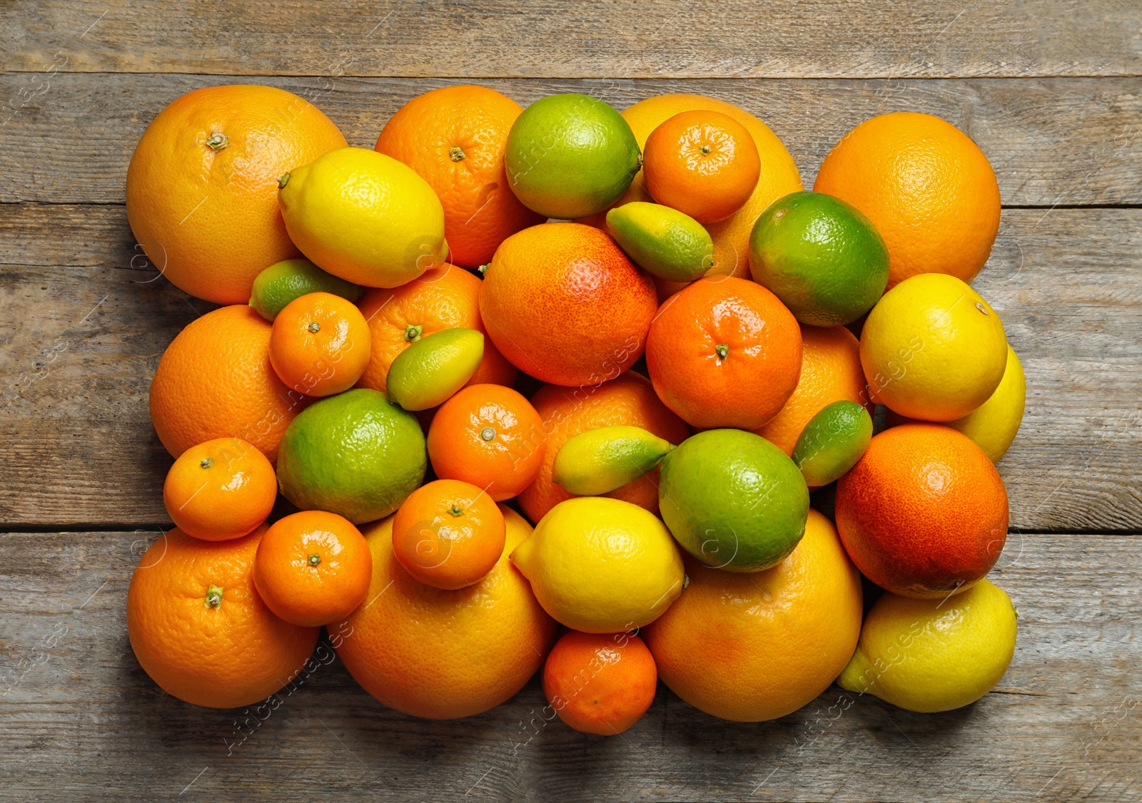 Photo of Flat lay composition with different citrus fruits on wooden background