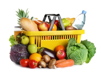 Photo of Shopping basket and grocery products on white background