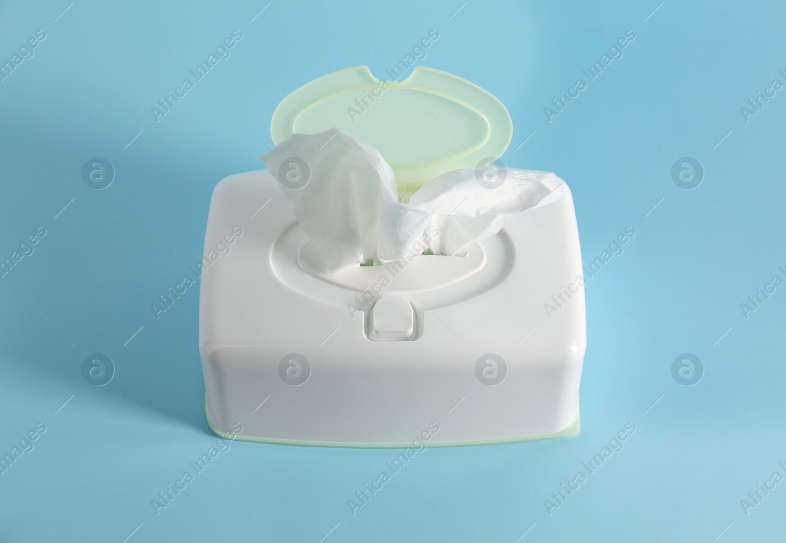 Photo of Box of paper tissues on light blue background