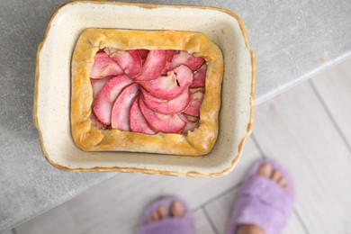 Tasty galette with apples on light grey table, top view