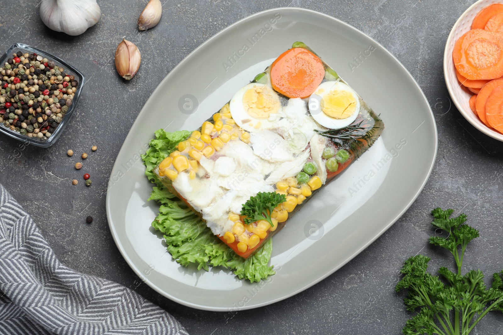 Photo of Delicious fish aspic served on grey table, flat lay