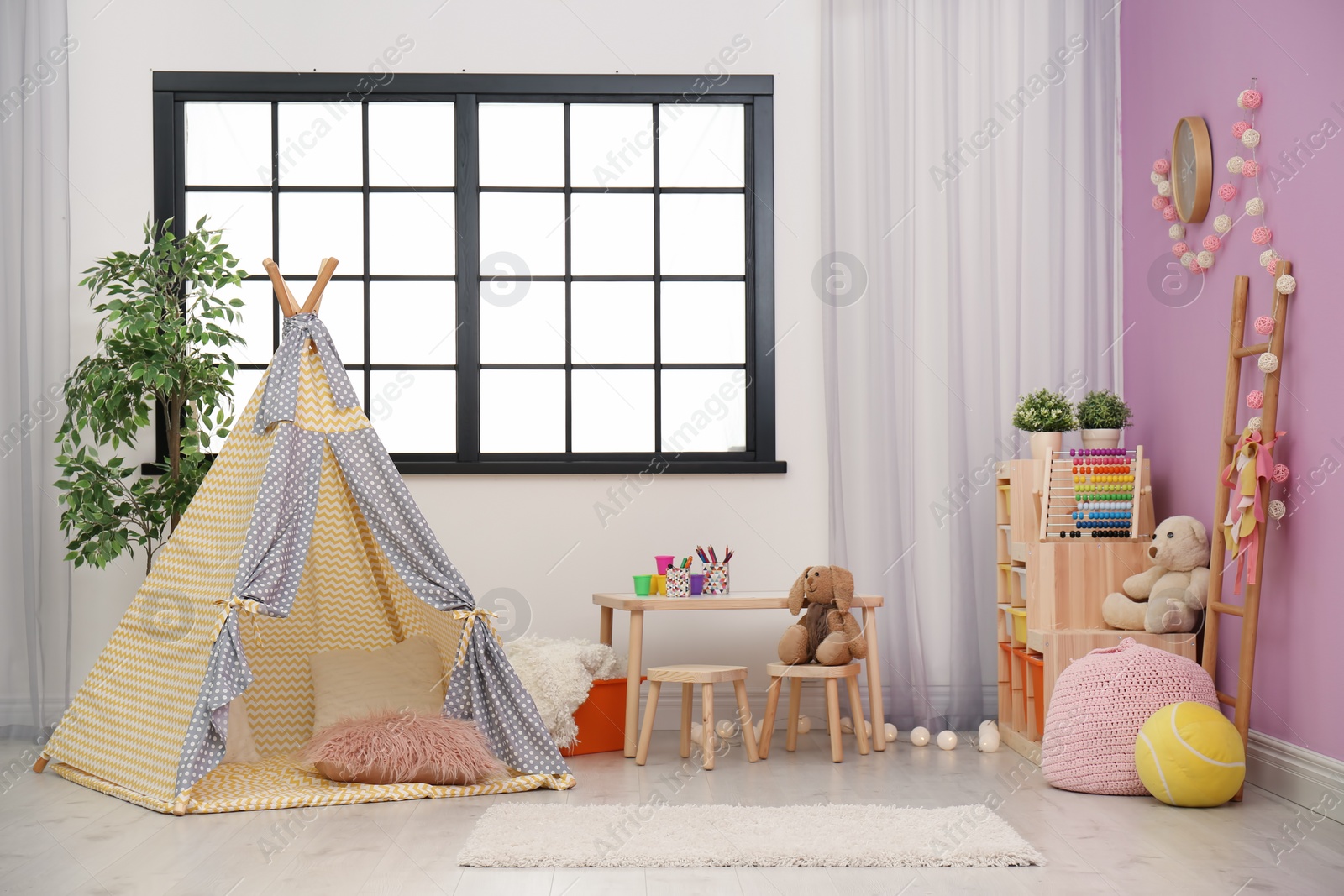 Photo of Modern nursery room interior with play tent for kids