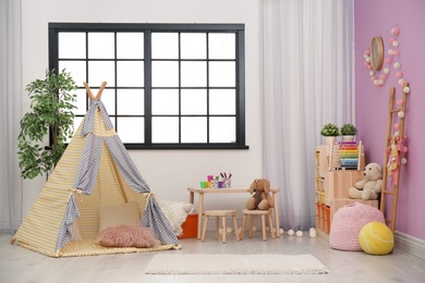 Modern nursery room interior with play tent for kids