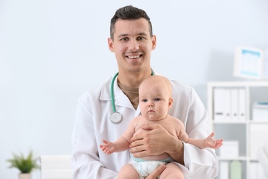 Children's doctor with cute baby in hospital