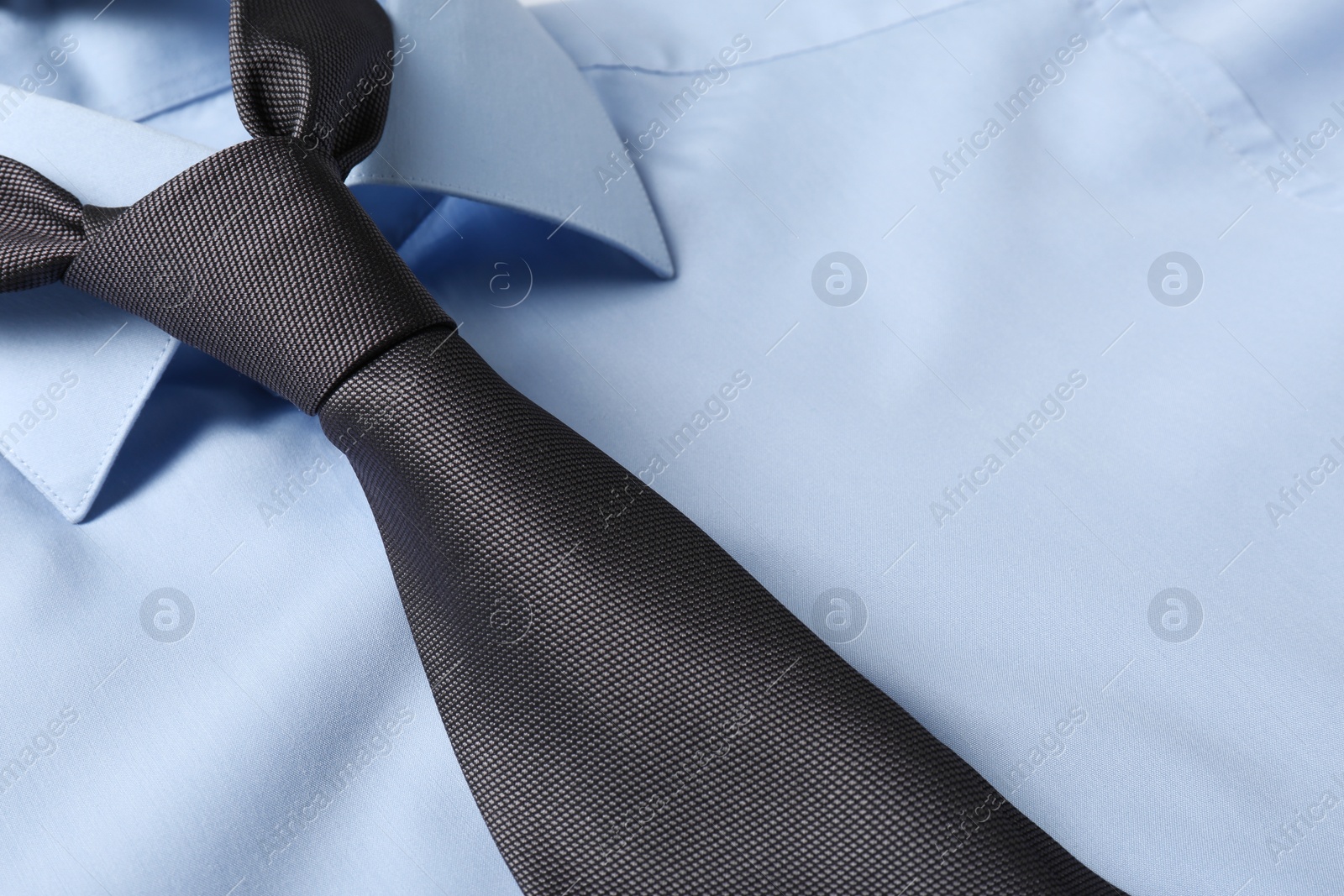 Photo of Color male necktie on blue shirt, closeup