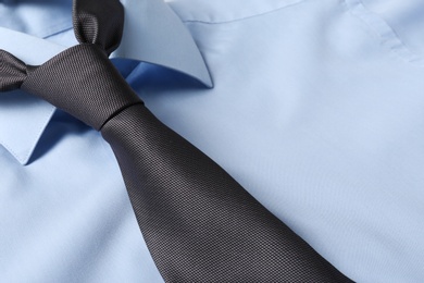 Color male necktie on blue shirt, closeup