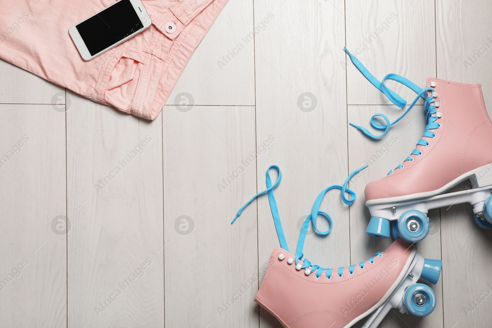 Photo of Flat lay composition with quad roller skates and space for text on wooden background