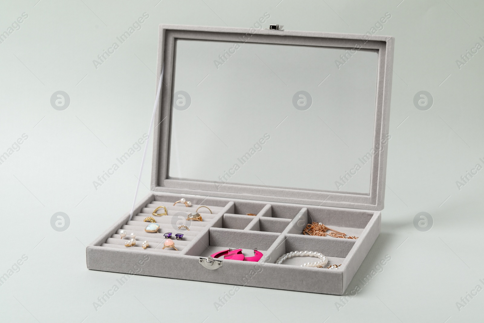 Photo of Jewelry box with many different accessories on light background