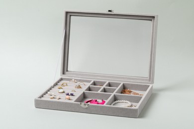 Jewelry box with many different accessories on light background