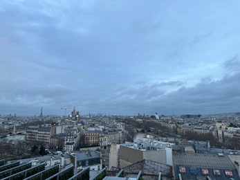 Photo of Beautiful buildings in Paris on cloudy day, view from hotel window