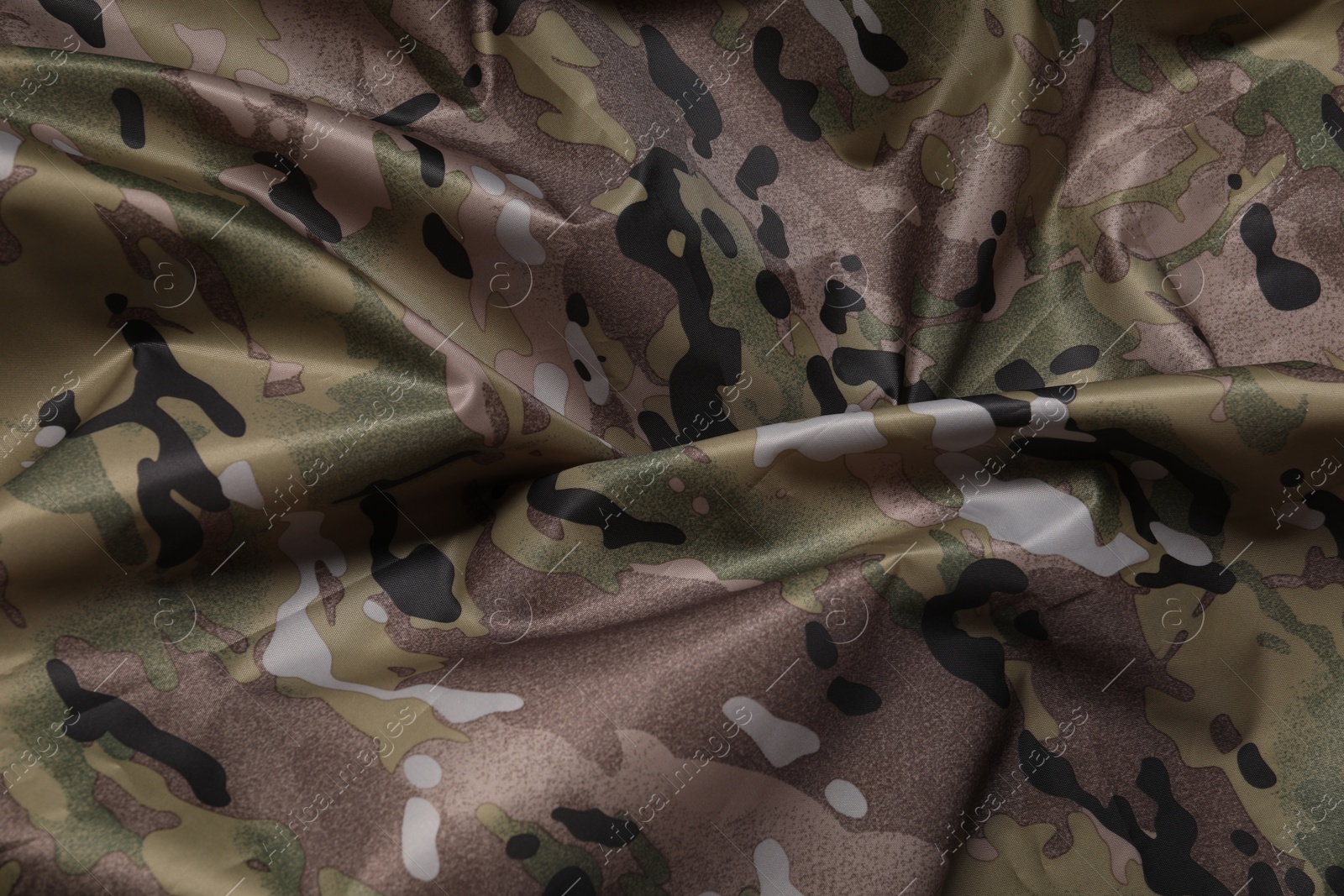 Photo of Texture of crumpled camouflage fabric as background, top view