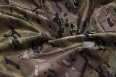 Texture of crumpled camouflage fabric as background, top view