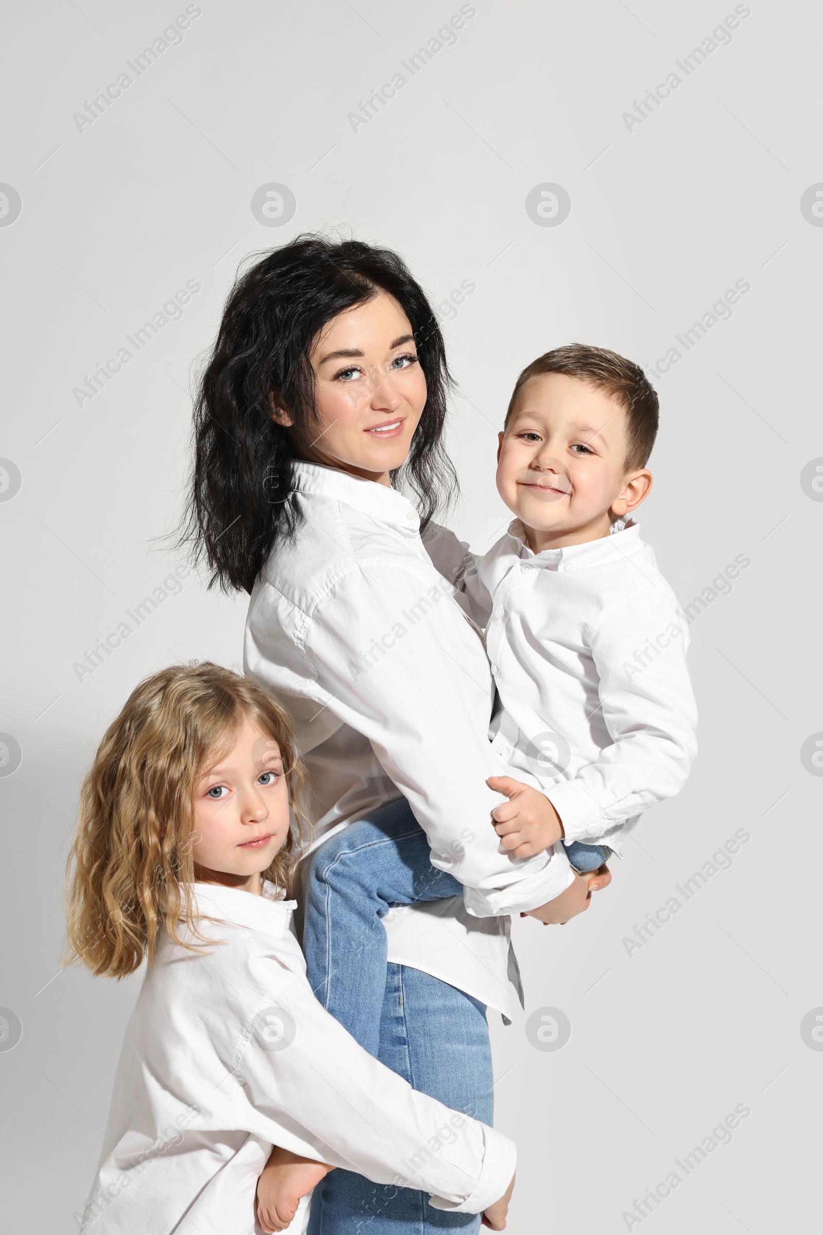 Photo of Little children with their mother on white background