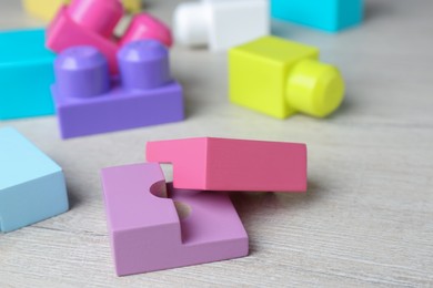 Photo of Colorful wooden blocks on white table, closeup. ABA therapy concept