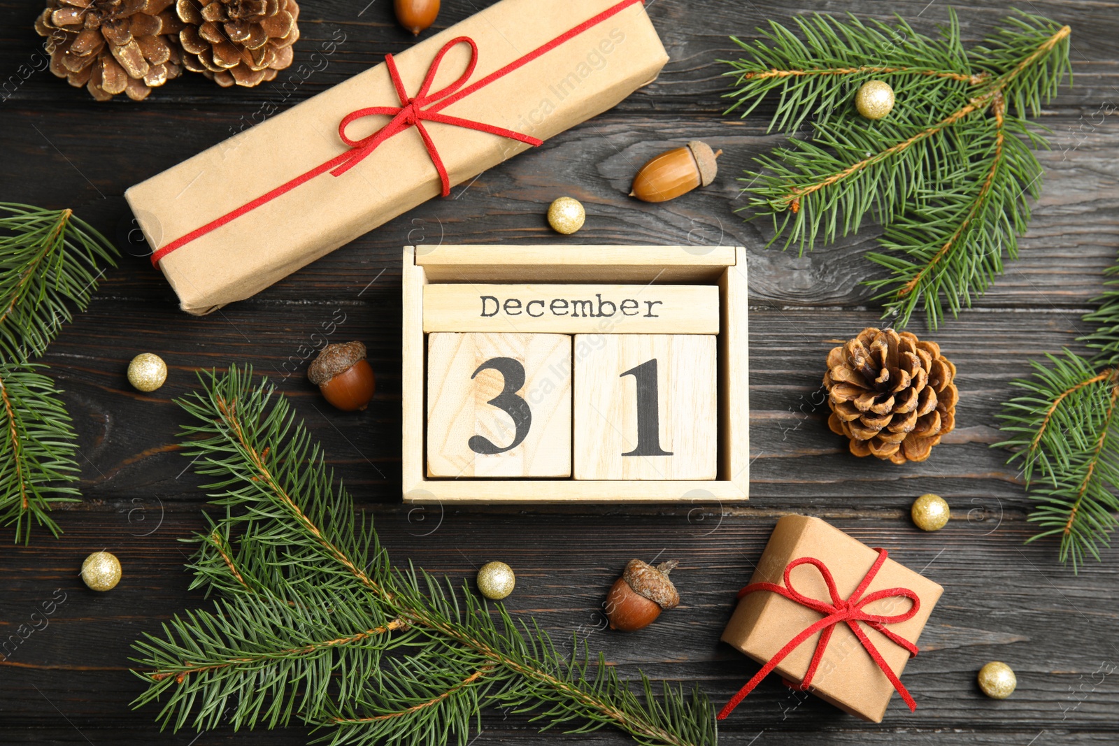 Photo of Flat lay composition with block calendar on black wooden table