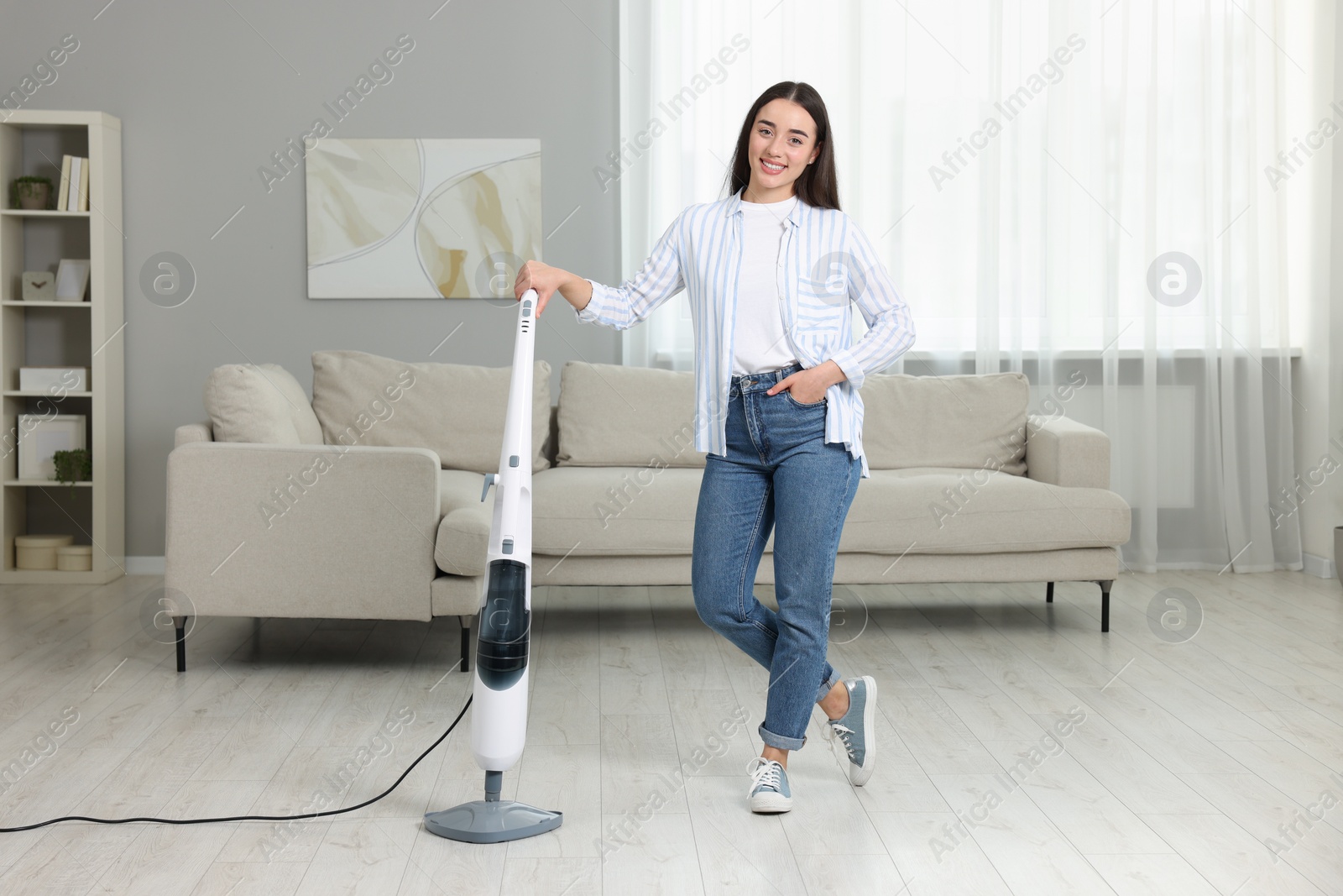 Photo of Happy woman with steam mop at home