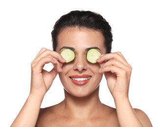 Photo of Woman covering eyes with cucumber slices on white background. Skin care