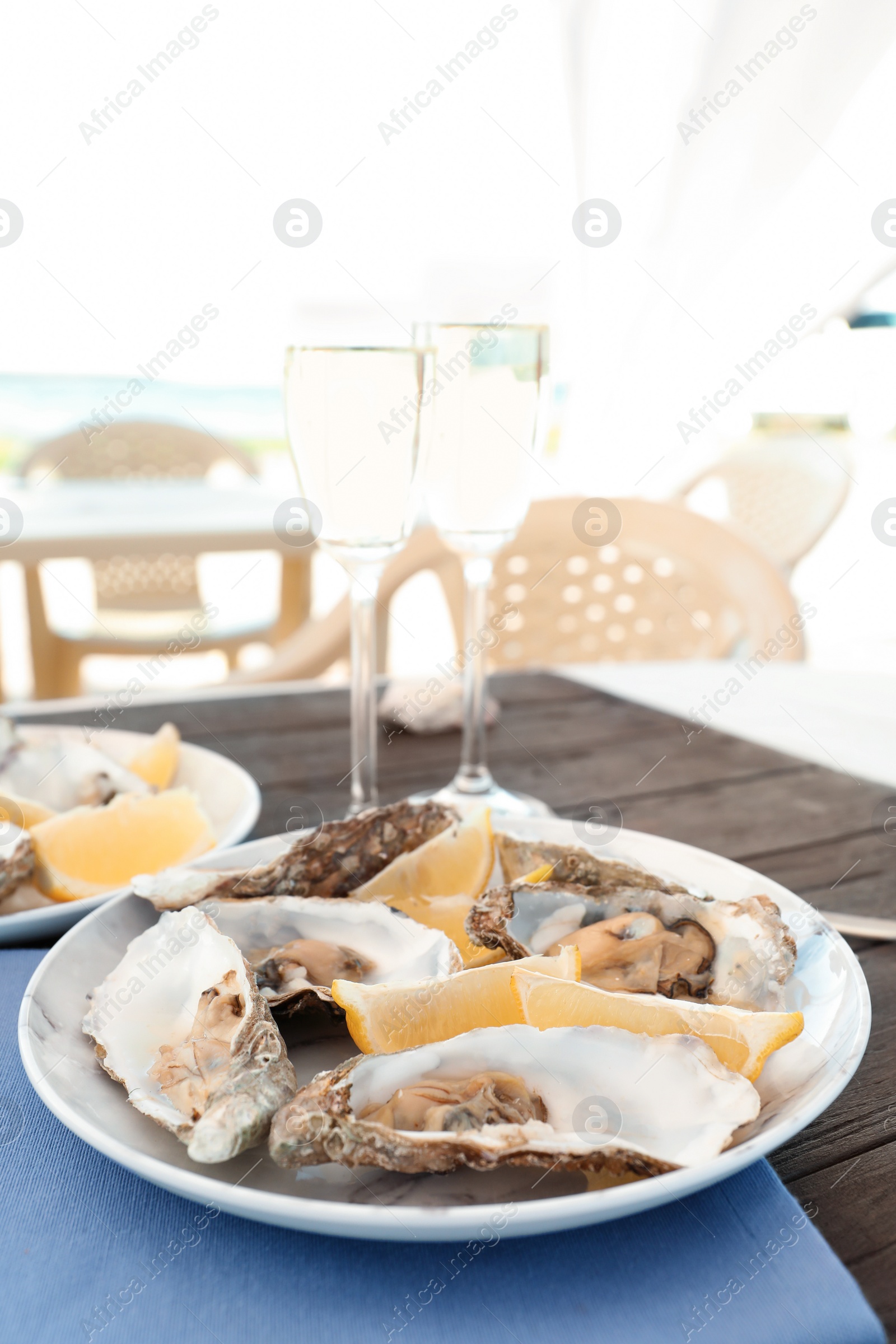 Photo of Fresh oysters with cut juicy lemon served on table