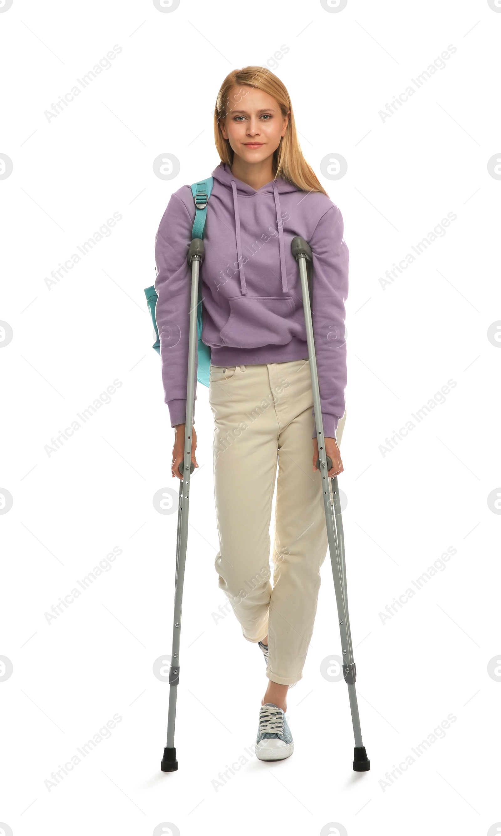 Photo of Young woman with axillary crutches on white background