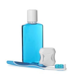 Photo of Mouthwash, toothbrush and dental floss isolated on white