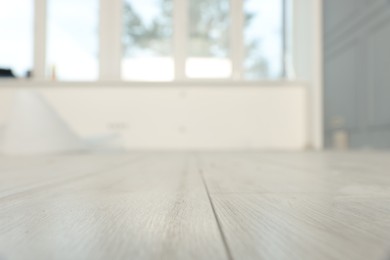 Photo of Empty room with new white laminated flooring, closeup
