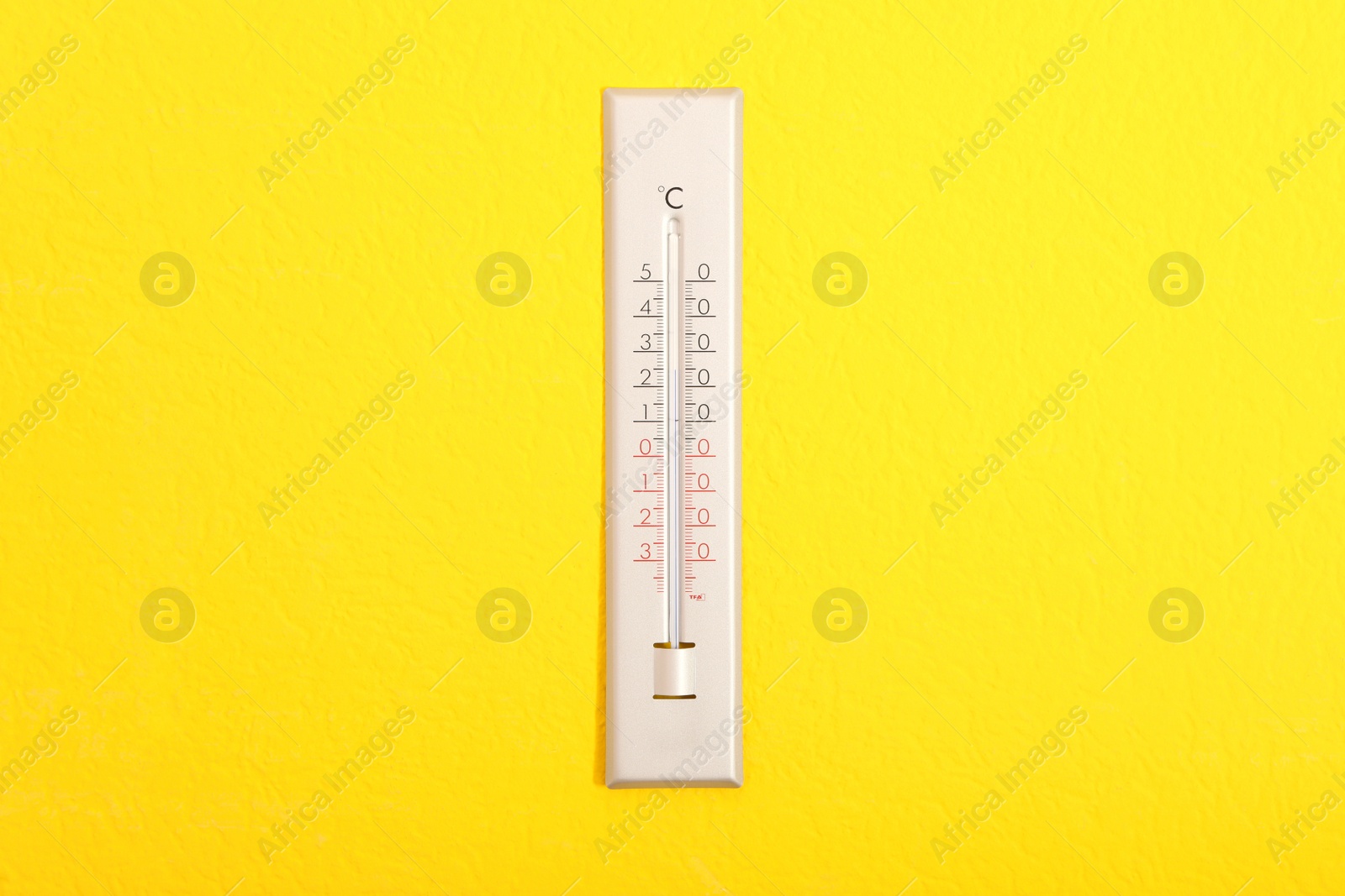 Photo of Weather thermometer hanging on bright yellow wall