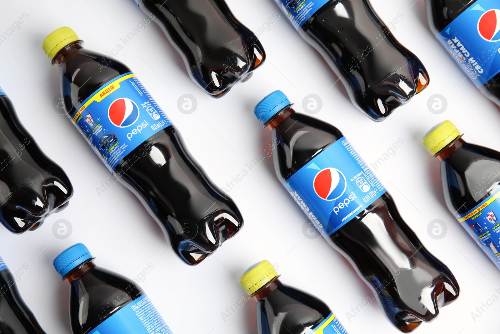 Photo of MYKOLAIV, UKRAINE - FEBRUARY 08, 2021: Plastic bottles of Pepsi on white background, flat lay