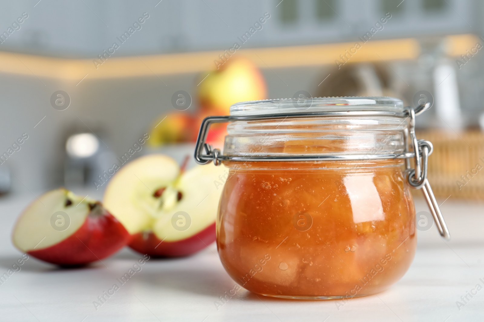 Photo of Delicious apple jam and fresh fruits on white table, closeup