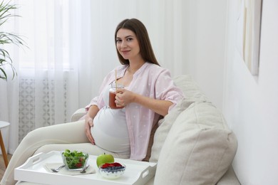 Pregnant woman eating breakfast at home. Healthy diet