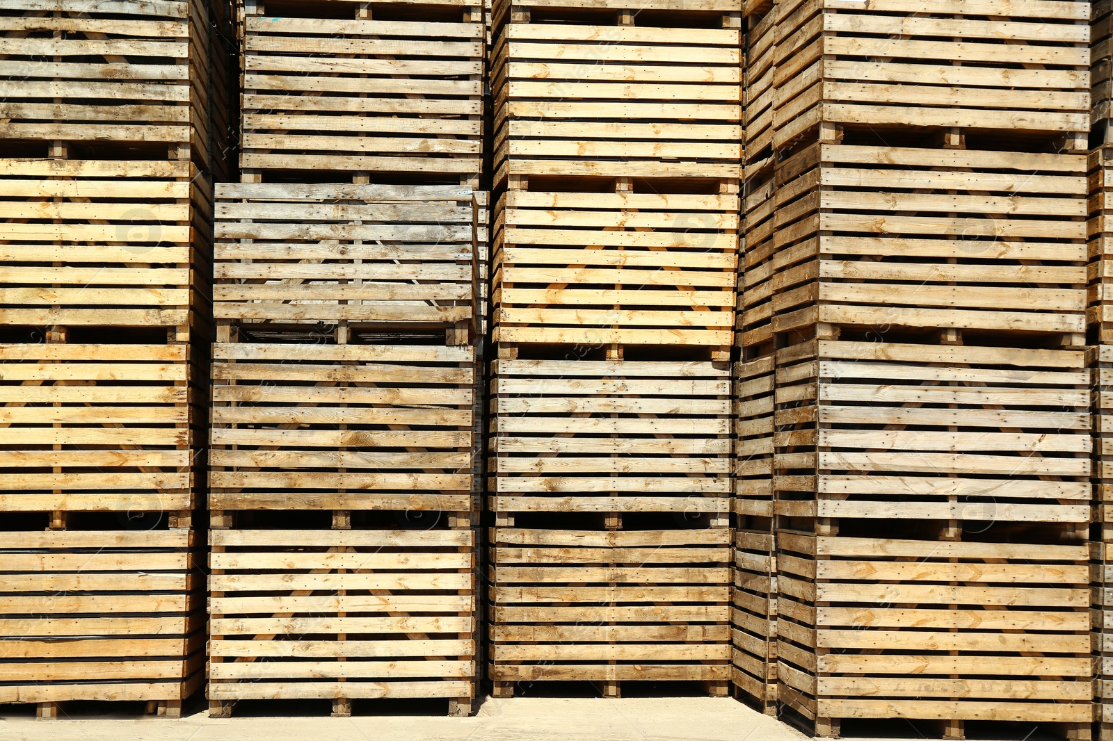 Photo of Pile of empty wooden crates outdoors on sunny day