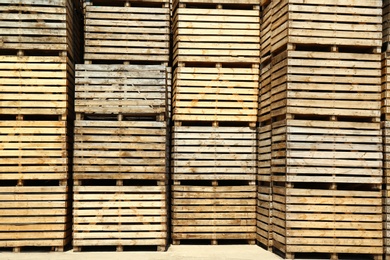 Pile of empty wooden crates outdoors on sunny day