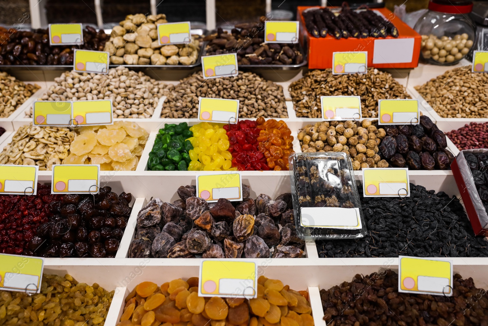 Photo of Assortment of delicious dried fruits and nuts at wholesale market