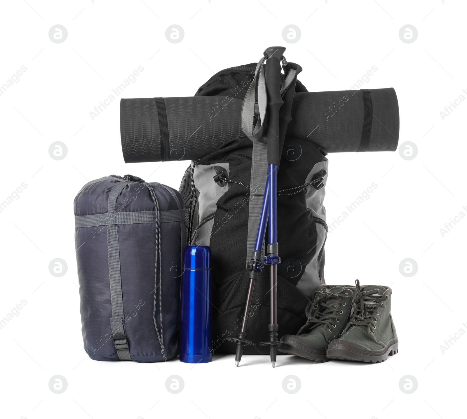 Photo of Pair of trekking poles and camping equipment for tourism on white background