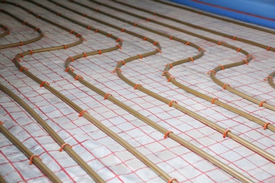 Photo of Installation of underfloor heating system in building