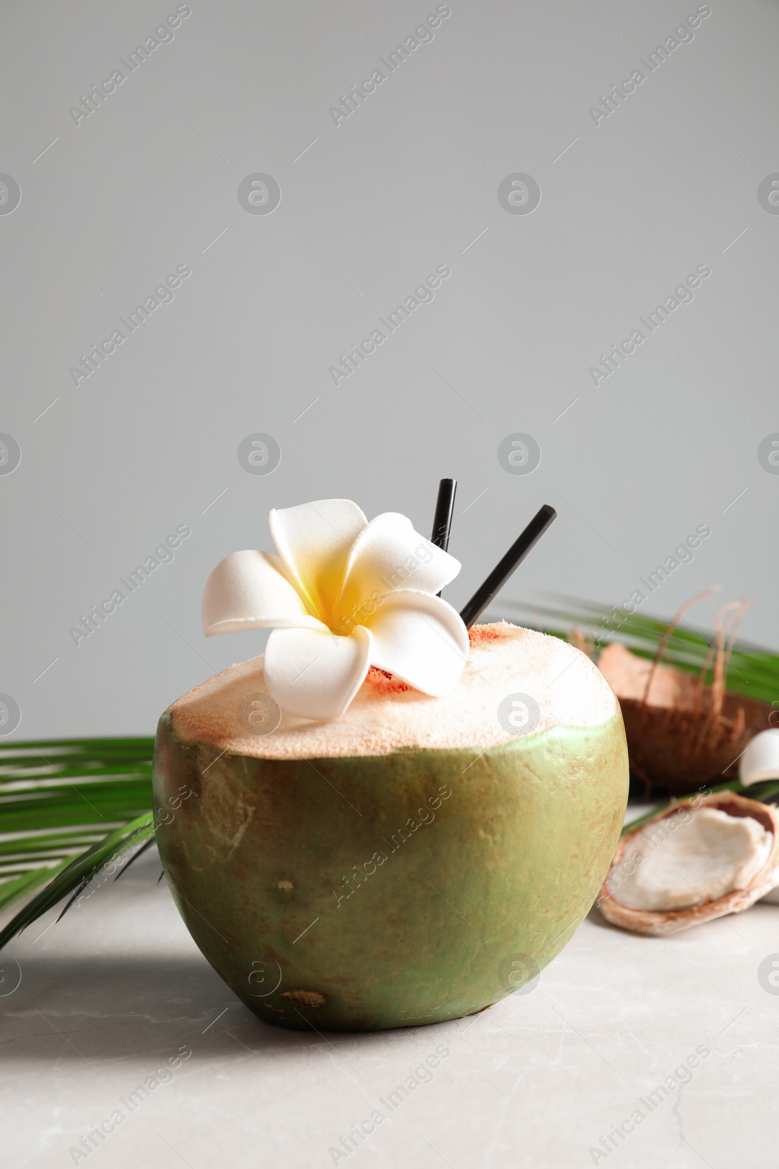 Photo of Fresh green coconut on table against gray background