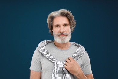 Photo of Portrait of handsome mature man on blue background